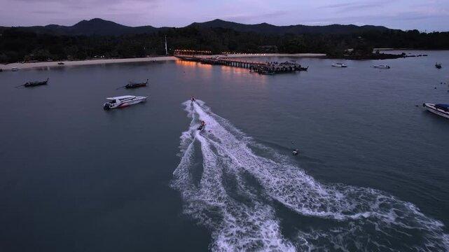AERIAL: Jets ski's in front of the Lo Chak Beach on Ko Yao Yai island in Thailand