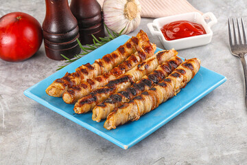 Grilled meat sausages wrapped bacon