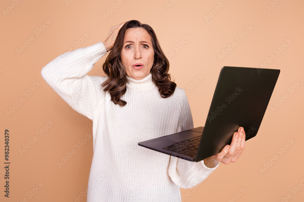 Wall mural Photo of worried nervous lovely woman wear white trendy clothes arm hold gadget isolated on beige color background