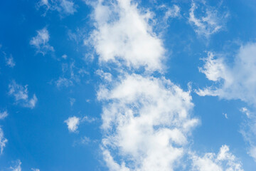 Sky is blue and clear with clouds. The sky is very bright and the sun is shining