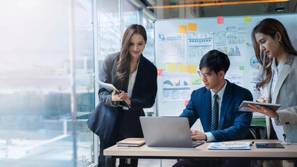 A diverse group of professionals brainstorming in a sleek, modern office with glass walls, using smartboards and laptops, a collaborative environment focused on innovation