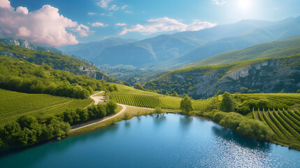 Obraz premium Scenic vineyard landscape with lake and mountains under a bright sky