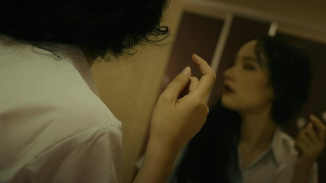 slow motion of sexy young college girl looking herself at the mirror while something Cath her attention and she move away