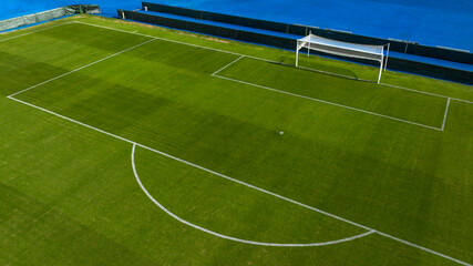 Aerial closeup of the penalty area on an empty grass soccer field. Here a penalty is taken in a...