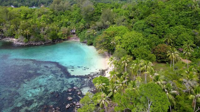 Tropical Island's Beach Kissed by Emerald Green Ocean Waters