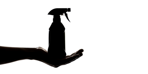 A hand holding a spray bottle