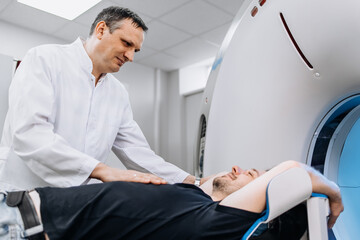 In a bright diagnostic center, a young man undergoes a CT or MRI scan using modern equipment. This...
