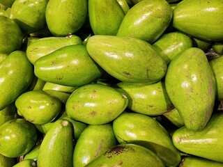 Pile of fresh Butter Avocados from Indonesia local farms, ready to be marketed. Butter Avocado or Alpukat Mentega is one type of avocado fruit that originates from the American continent.