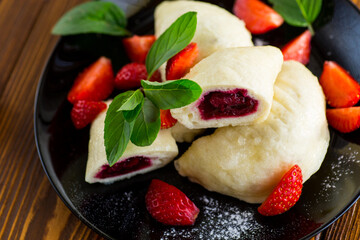 cooked sweet homemade steamed dumplings with strawberries