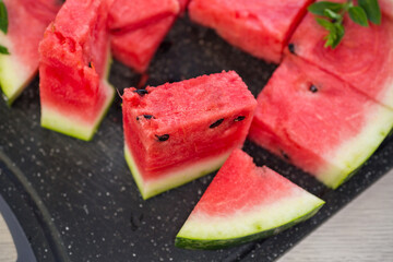 pieces of ripe red watermelon, close-up, on a board