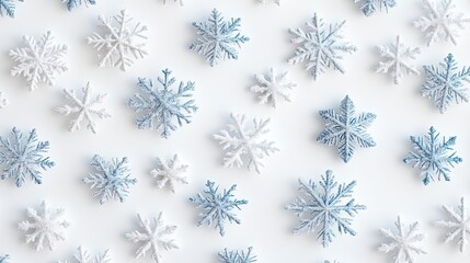 Beautiful arrangement of snowflakes in various shades of blue and white, perfect for winter-themed designs and backgrounds.