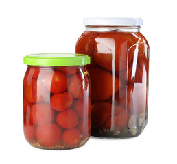 Tasty pickled tomatoes in jars isolated on white