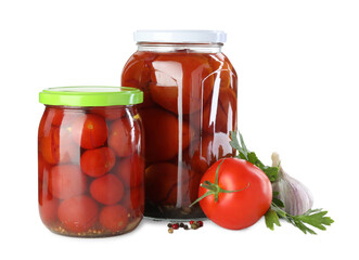 Tasty pickled tomatoes in jars, fresh vegetable and spices isolated on white