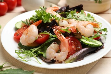 Delicious shrimp salad with vegetables on wooden table, closeup