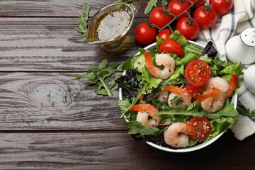 Delicious shrimp salad and ingredients on wooden table, flat lay. Space for text