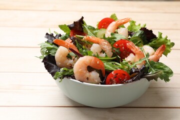 Delicious shrimp salad with vegetables on wooden table, closeup