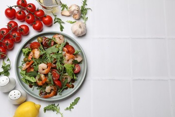 Delicious shrimp salad with ingredients on white tiled table, flat lay. Space for text