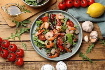 Delicious shrimp salad with ingredients on wooden table, flat lay