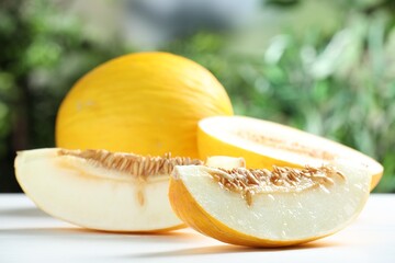 Fresh ripe melons on white table outdoors, closeup