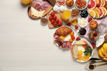 Different tasty food served for brunch on white wooden table, flat lay. Space for text