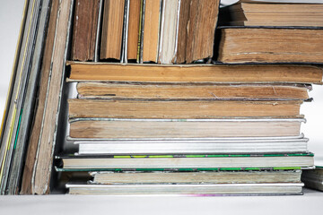 A stack of old books on a neutral background.