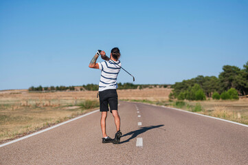 young man playing golf