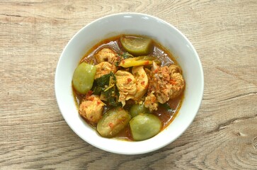 spicy boiled chicken with mixed vegetable in jungle curry soup Thai food in bowl