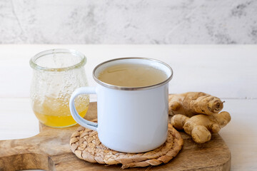 Ginger tea in a mug on a white background