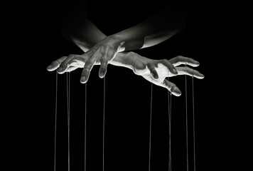 Puppeteer's hands with strings on each finger on black background.