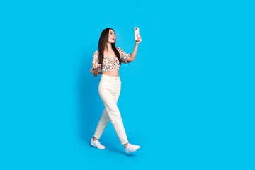 Photo of lovely gorgeous woman wear trendy print clothes travel blog isolated on blue color...