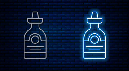 Glowing neon line Tequila bottle icon isolated on brick wall background. Mexican alcohol drink. Vector