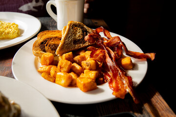 Breakfast plate with bacon toast and home fries 