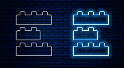 Glowing neon line Toy building block bricks for children icon isolated on brick wall background. Vector