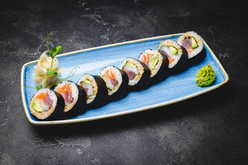 Sushi with tuna, salmon and avocado. Rolls with seafood close-up. Asian food