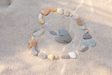 Rocks shaped to make Heart in beach sand 