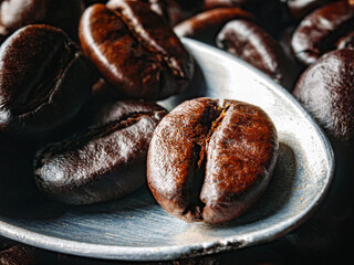 Roasted coffee bean on a stainless steel spoon, Close-up of fresh roasted coffee bean, Wallpapers of  roasted coffee bean, macro