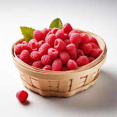 raspberries in a woven basket isolated on white background