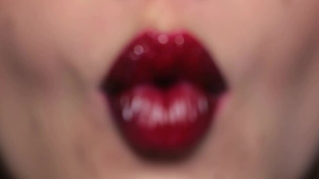 Close up lips. Makeup artist applies lipstick. Visage, painting cosmetics of young beauty model. Fashion lipstick on lips. Makeup lipstick. Professional makeup artist does makeup lips with lipstick.