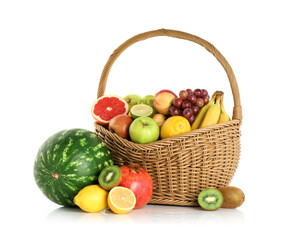 Many different fresh fruits in wicker basket isolated on white
