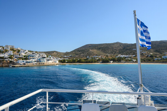 Deck of ferry with Greek flag leaving Donousa island. Cyclades, Greece