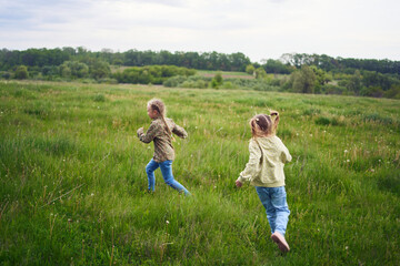 girls play catch up in a field