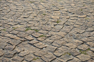brown old cobblestones in the background, cobblestones in the background, textured symmetrical slabs close up 