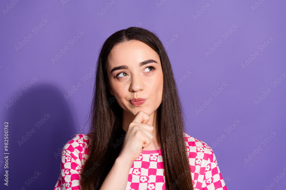 Poster Photo of pretty young woman look empty space ponder wear checkered t-shirt isolated on purple color background