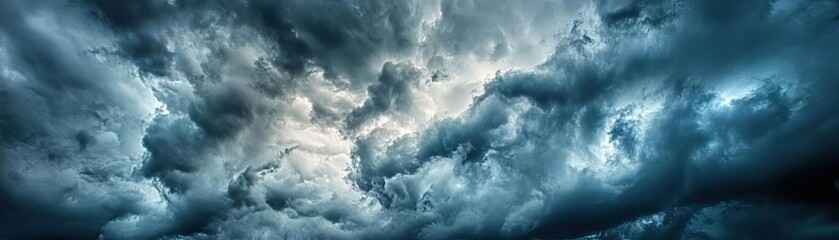 Obraz premium Dramatic and moody cloud formation with shades of blue and gray, capturing the essence of an impending storm.