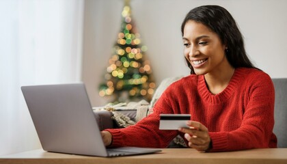 Christmas season, a woman in a cozy festive sweater is joyfully using her laptop and credit card to browse online for holiday gifts