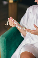 Bride Holding Elegant Pearl Necklace – Perfect for Wedding Preparation, Romance, and Jewelry Photography