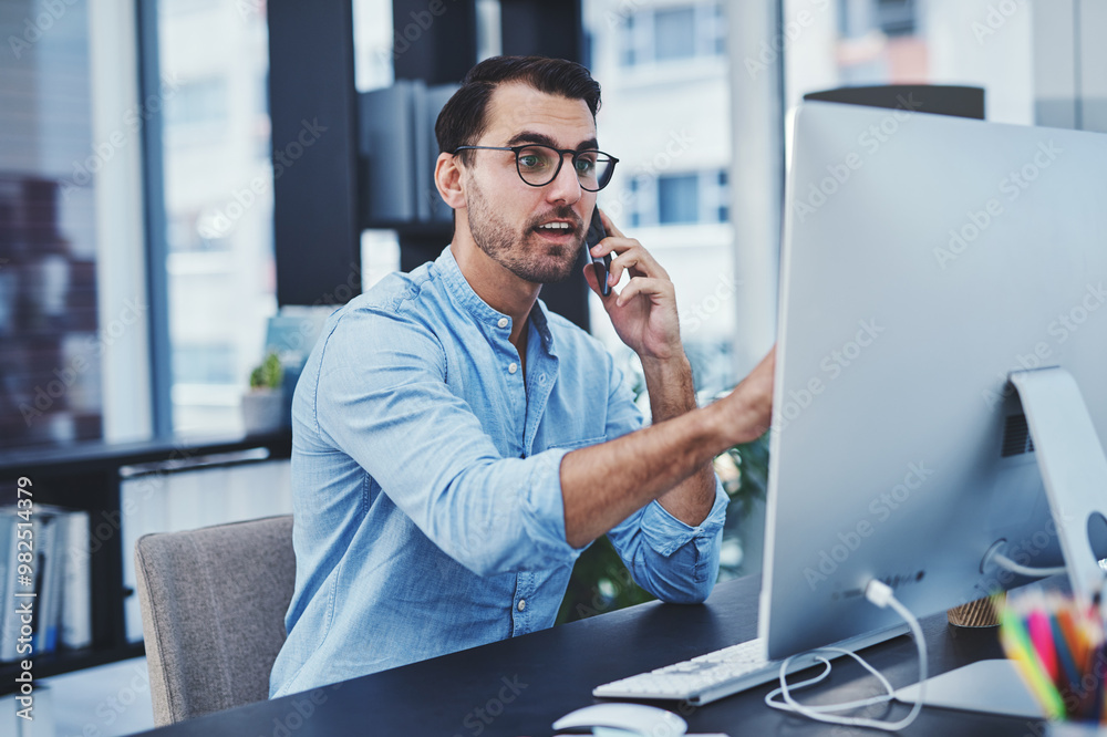 Wall mural Office, man and conversation on computer with phone call for consultation and assistance as IT specialist. Male person, employee and reading on pc in desk for communication, networking and connection