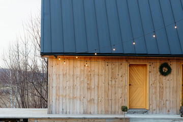 Wooden cabin with string lights is ready for christmas party