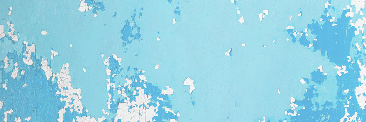 Blue peeling paint on the wall. Old concrete wall with cracked flaking paint. Weathered rough painted surface with patterns of cracks and peeling. High resolution texture for background and design.