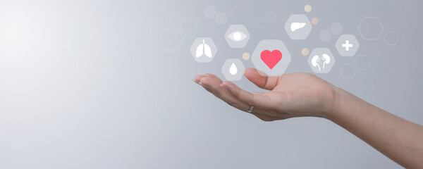 close up young woman hand gesture and show about internal organ donation of human cell on blue background for kindness of living and medical nonprofit concept